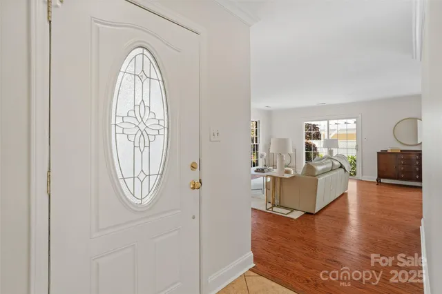 a view of living room with furniture mirror and wooden floor