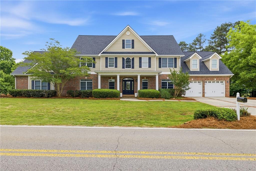 4337 Mountain View Road Oakwood, GA 30566 - Photo 5 of 84 a front view of a house with a yard