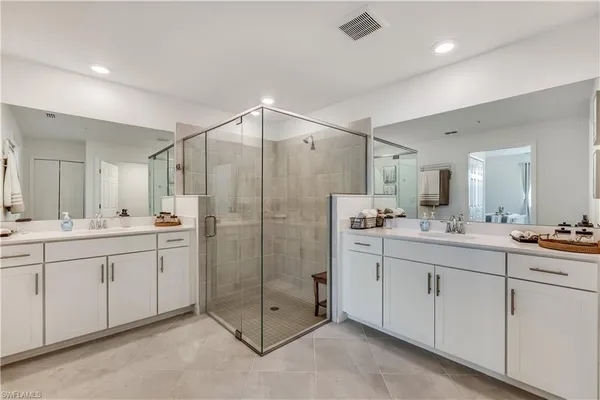 a bathroom with a shower sink and mirror