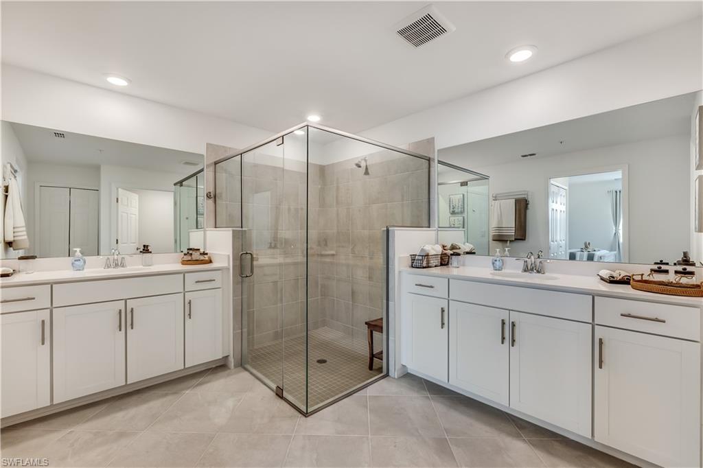 43330 Water Bird Way, Unit 6911 Punta Gorda, FL 33982 - Photo 12 of 17 Bathroom with a shower with door, tile flooring, and vanity