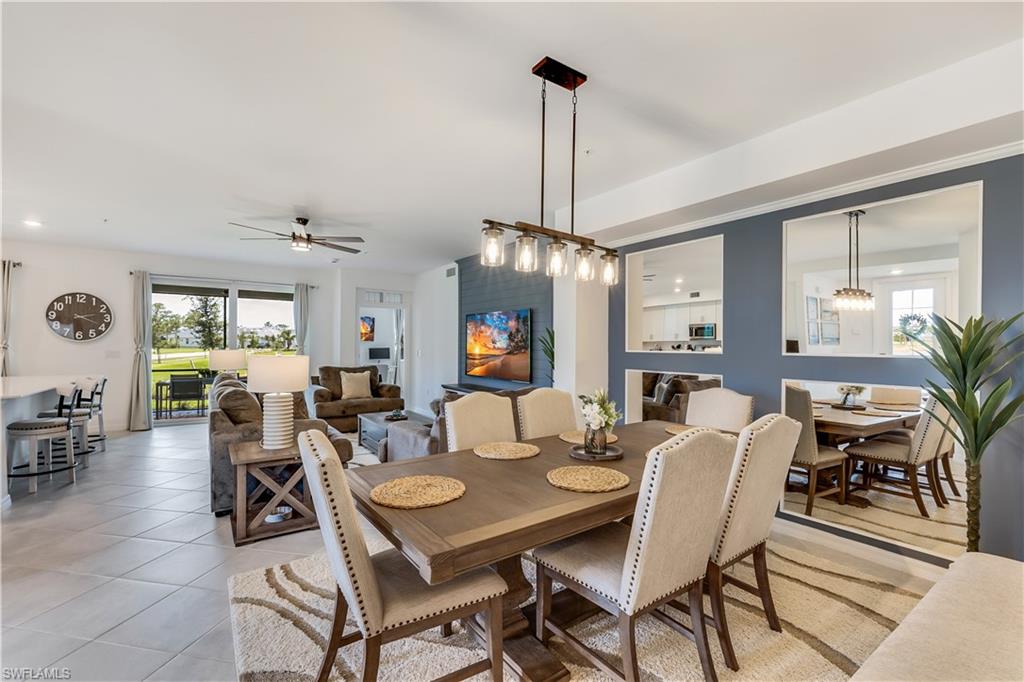 43330 Water Bird Way, Unit 6911 Punta Gorda, FL 33982 - Photo 4 of 17 Tiled dining space featuring ceiling fan with notable chandelier and a wealth of natural light