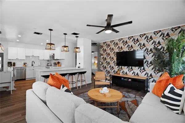 a kitchen with stainless steel appliances a stove microwave and refrigerator
