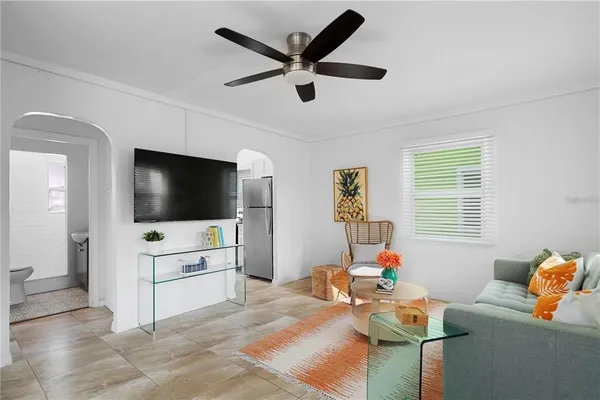 a living room with furniture and a wooden floor