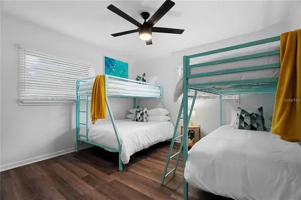 a large bed sitting in a bedroom next to a window