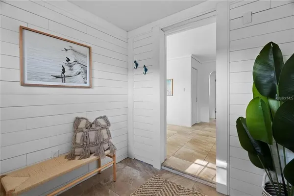 a kitchen with stainless steel appliances a refrigerator a sink a stove and white cabinets