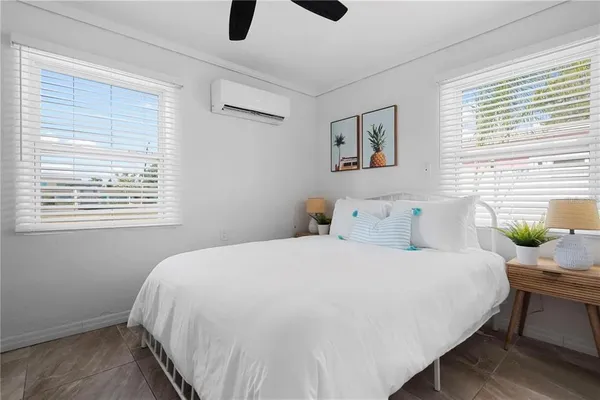 a bedroom with a bed and a painting on the wall