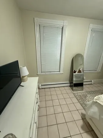 a bedroom with a bed and a mirror