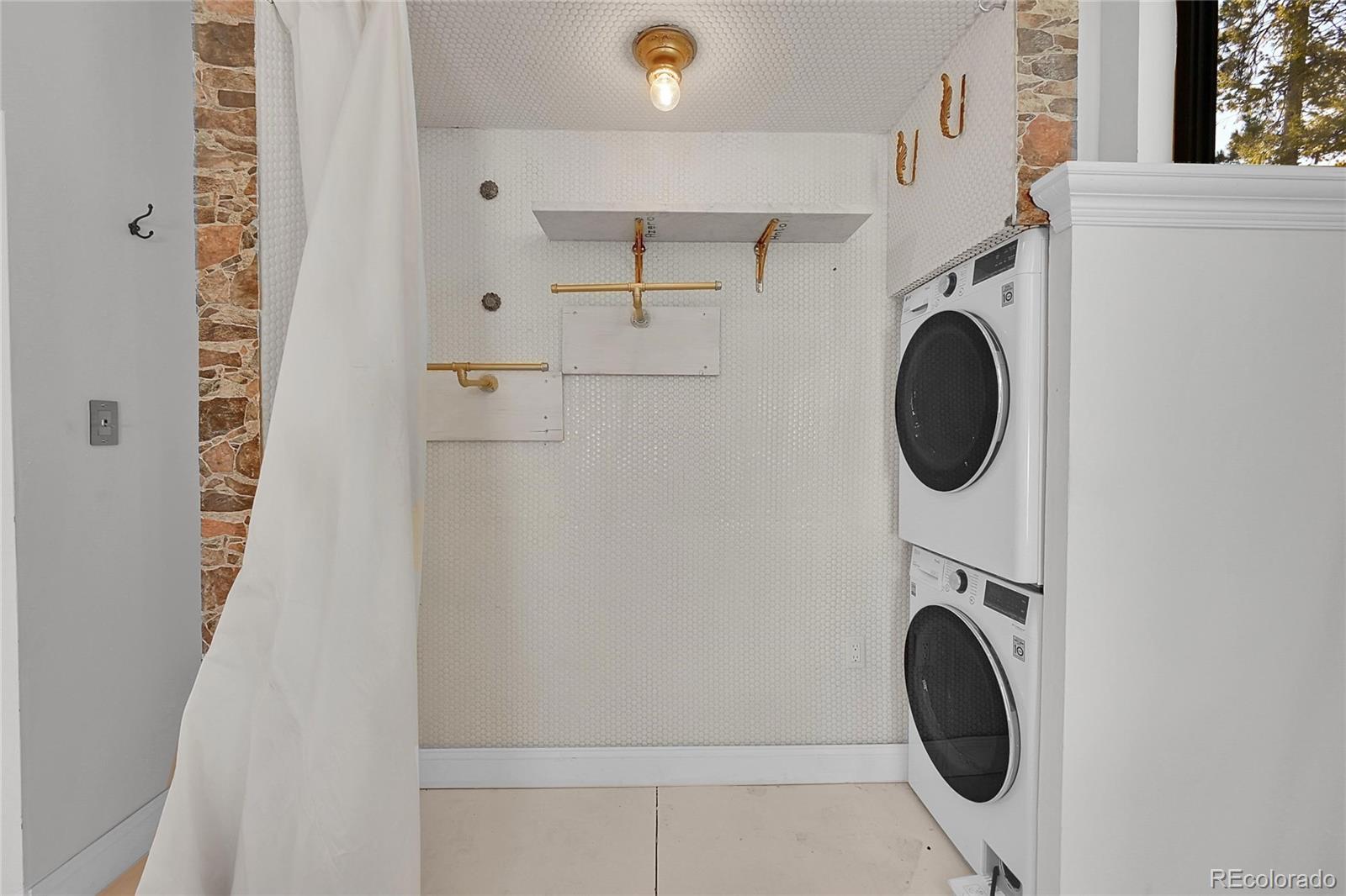 148 Ridge Lane Bailey, CO 80421 - Photo 16 of 25 a utility room with dryer and washer