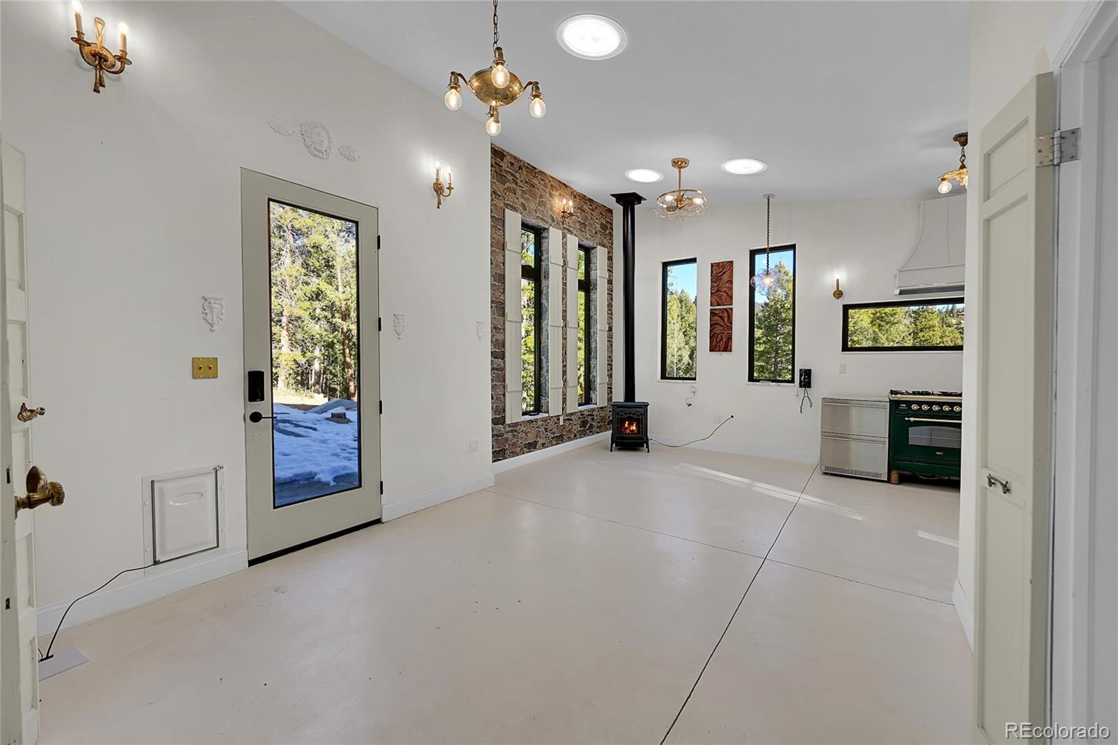 148 Ridge Lane Bailey, CO 80421 - Photo 6 of 25 a view of a hallway with wooden floor and a bathroom