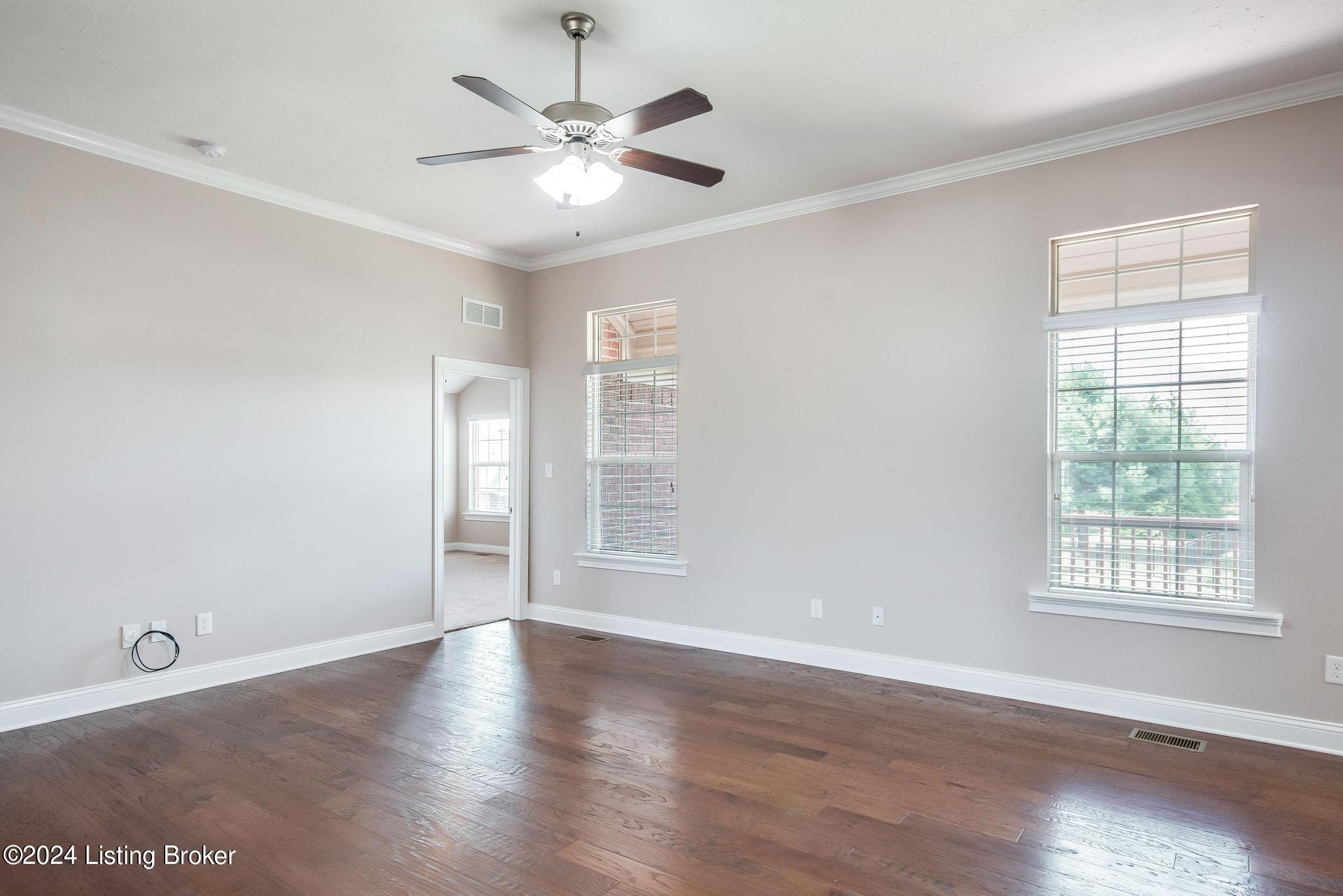 283 Autumn Ridge Drive Mount Washington, KY 40047 - Photo 5 of 41 Great Room with a new ceiling fan/light fixture, gleaming hard wood flooring, 2 windows with transoms above allowing allot of lighting, fresh coat of paint, wide open to the Eat-In Kitchen/Dining Area and is the center point/gathering space for this home!!