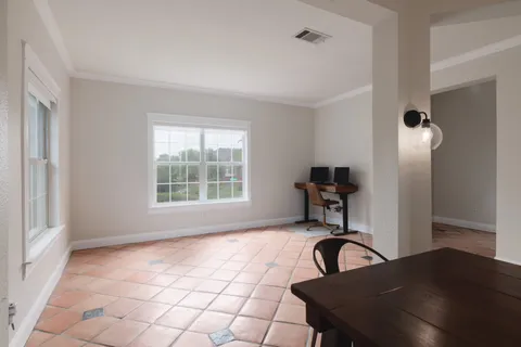 a view of a workspace room with a window