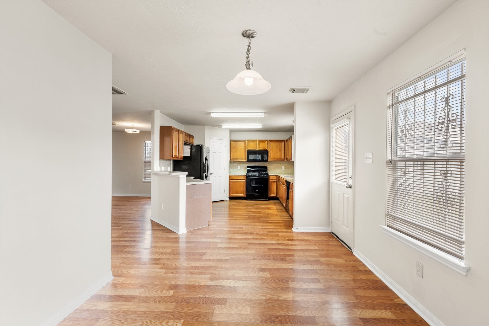 3111 Holly Ranch Drive Katy, TX 77494 - Photo 13 of 28 a view of a kitchen with furniture and wooden floor