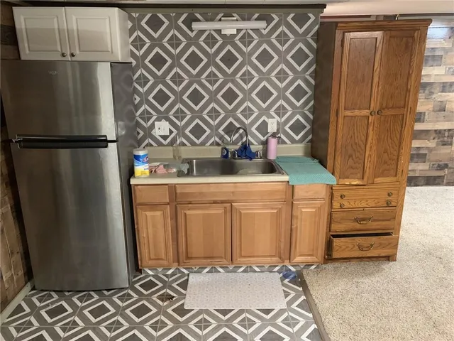 a kitchen with a sink a stove and cabinets