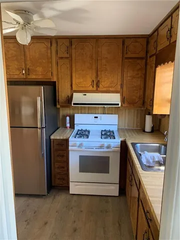 a white toilet sitting next to a bathroom sink and a shower