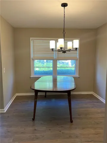 a view of a room with a table and chairs