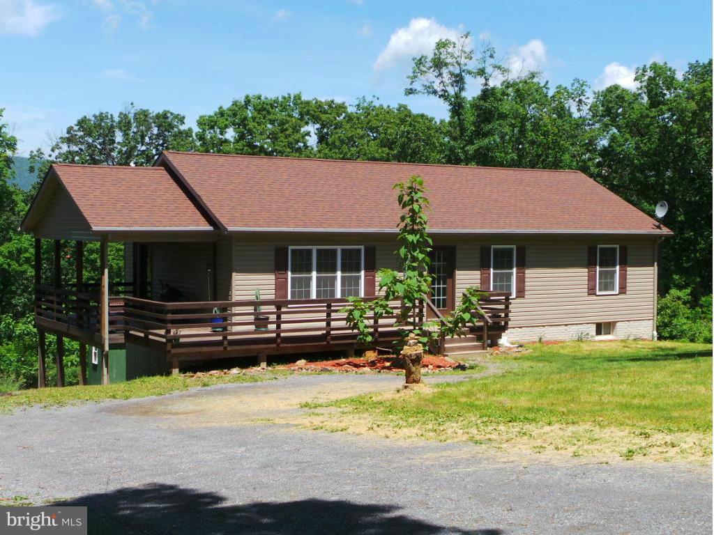 4258 Timber Ridge Road Berkeley Springs, WV 25411 - Photo 1 of 26 a view of a house with swimming pool and sitting area