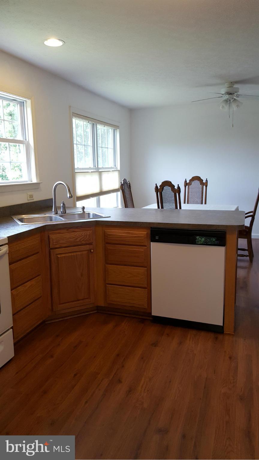 4258 Timber Ridge Road Berkeley Springs, WV 25411 - Photo 4 of 26 a kitchen with stainless steel appliances granite countertop a sink and wooden cabinets
