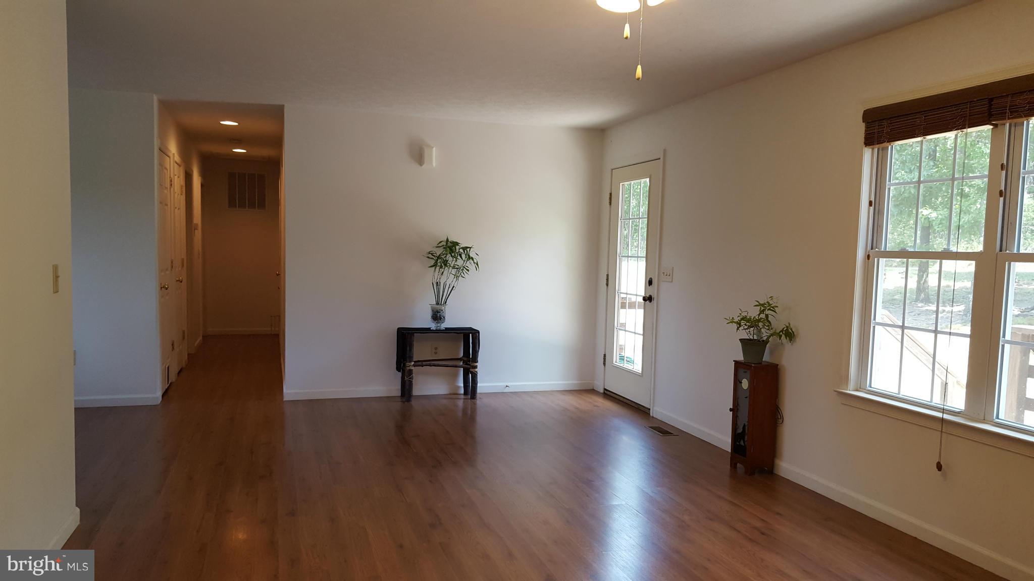 4258 Timber Ridge Road Berkeley Springs, WV 25411 - Photo 7 of 26 a view of an empty room with wooden floor and a window