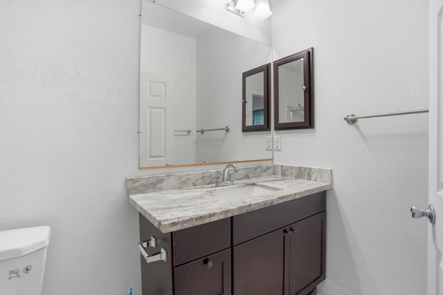 5680 Power Inn Road Sacramento, CA 95824 - Photo 29 of 48 a bathroom with a granite countertop sink and a mirror
