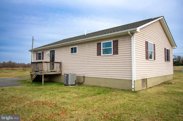 a view of a house with a backyard and a chair