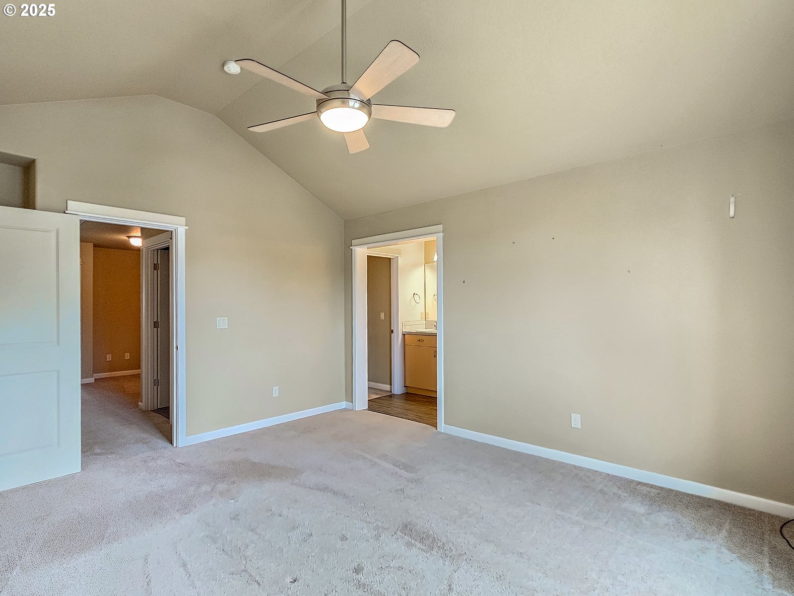 15621 Southeast Eckert Lane Damascus, OR 97089 - Photo 17 of 24 an empty room with a chandelier fan and a bathroom