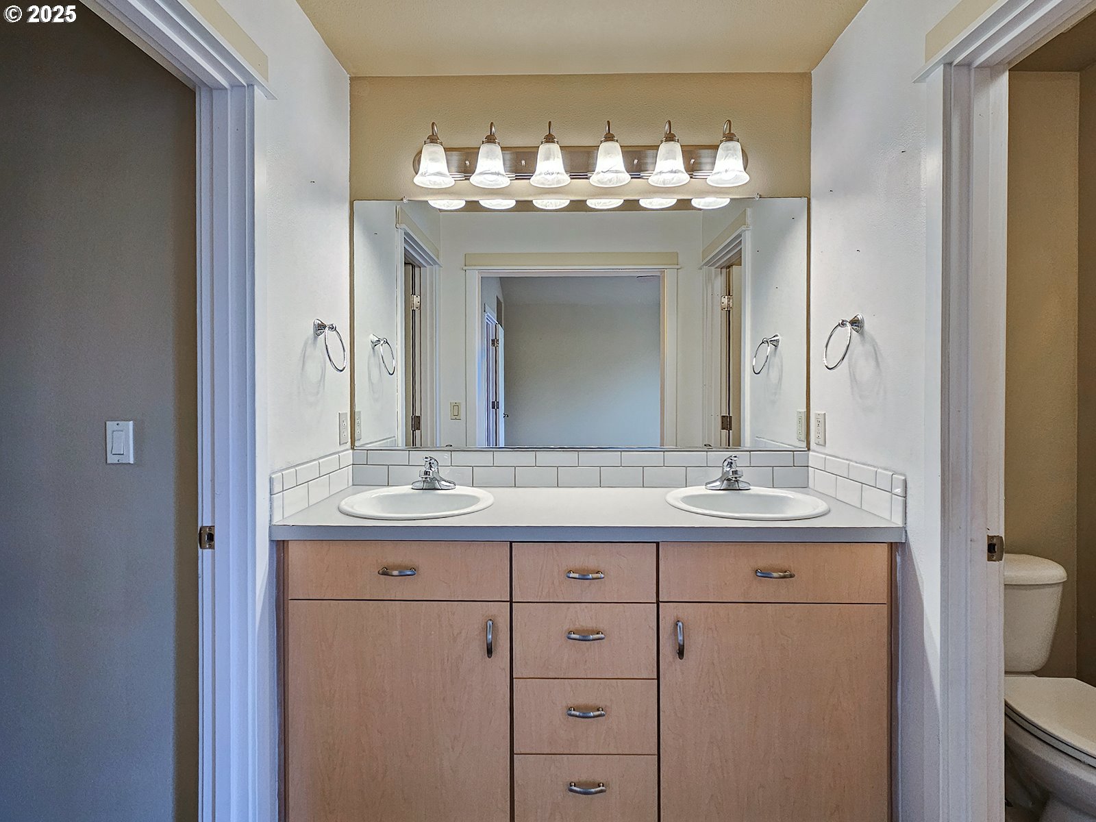 15621 Southeast Eckert Lane Damascus, OR 97089 - Photo 18 of 24 a bathroom with a granite countertop sink a large mirror and a