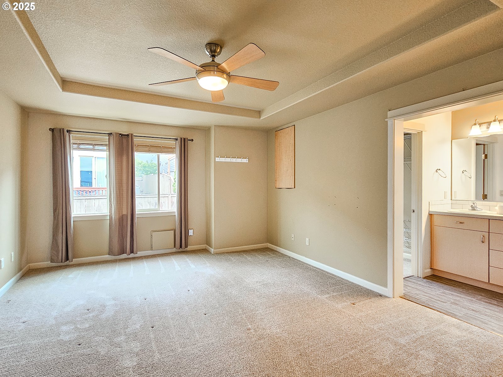 15621 Southeast Eckert Lane Damascus, OR 97089 - Photo 21 of 24 an empty room with chandelier fan and windows
