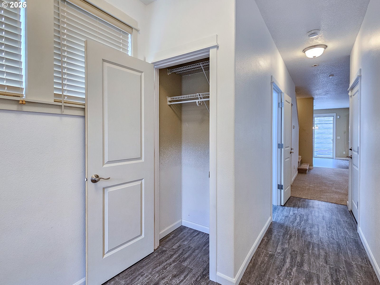 15621 Southeast Eckert Lane Damascus, OR 97089 - Photo 3 of 24 a view of a hallway with wooden floor and closet