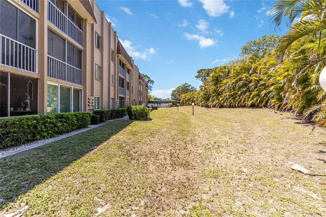 an aerial view of a residential building with an outdoor space