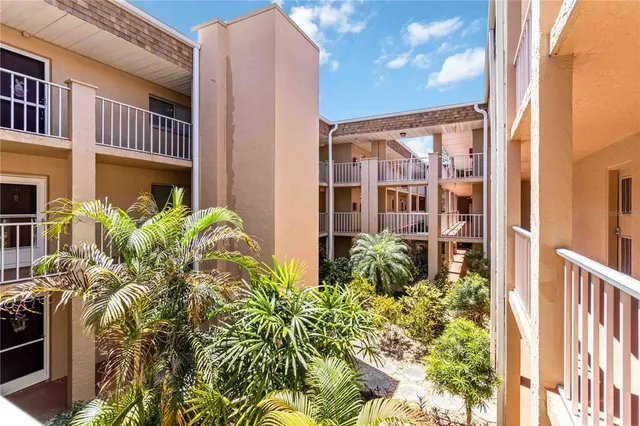 a view of a hallway with wooden floor and a bathroom
