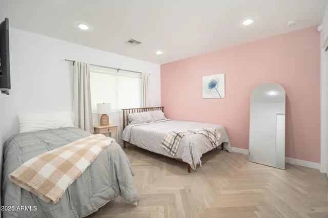 a bedroom with a bed and a night stand