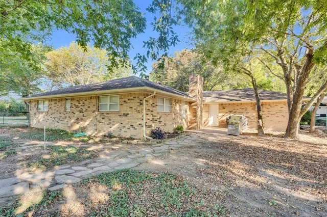 a view of a swimming pool with a yard and wooden fence