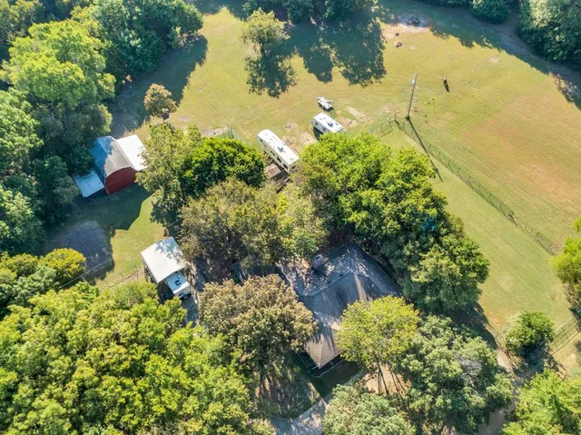an aerial view of a house with a yard and lake view