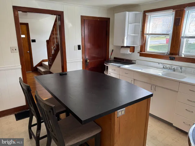 a view of a workspace with furniture and window