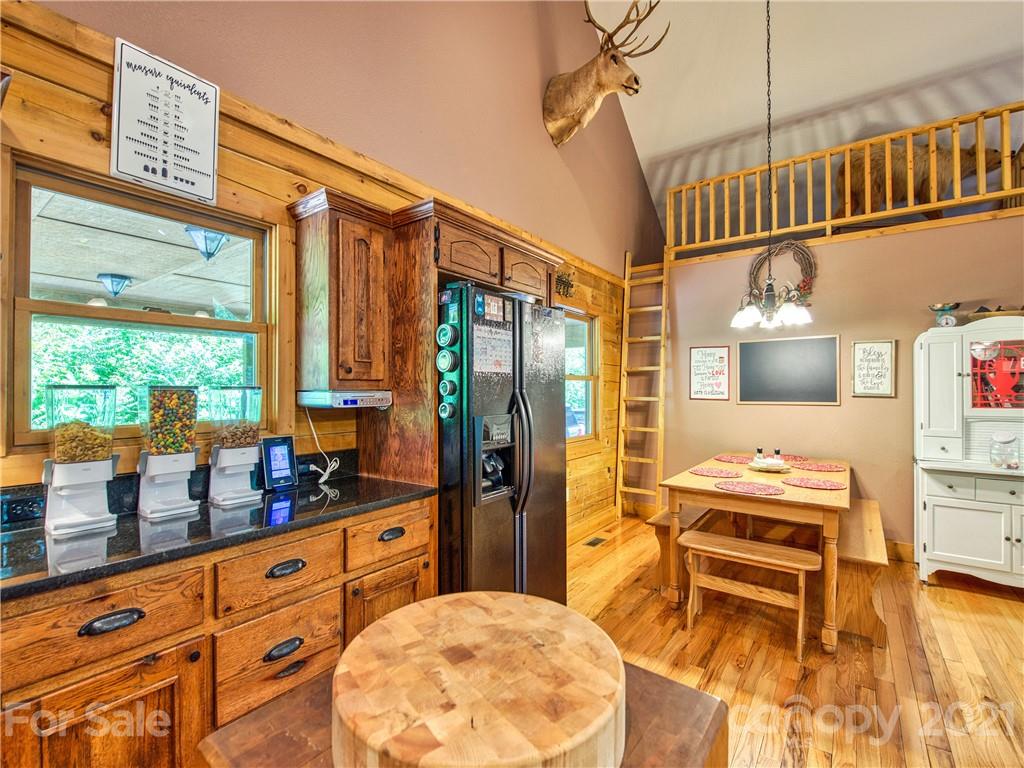 273 Mellow Springs Road Waynesville, NC 28786 - Photo 14 of 40 a kitchen that has a lot of cabinets stainless steel appliances and a large window