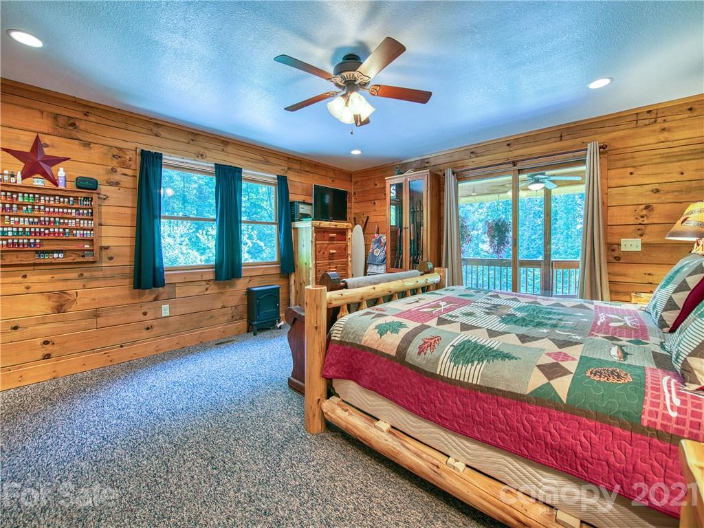273 Mellow Springs Road Waynesville, NC 28786 - Photo 19 of 40 a bed sitting in a spacious bedroom next to a window