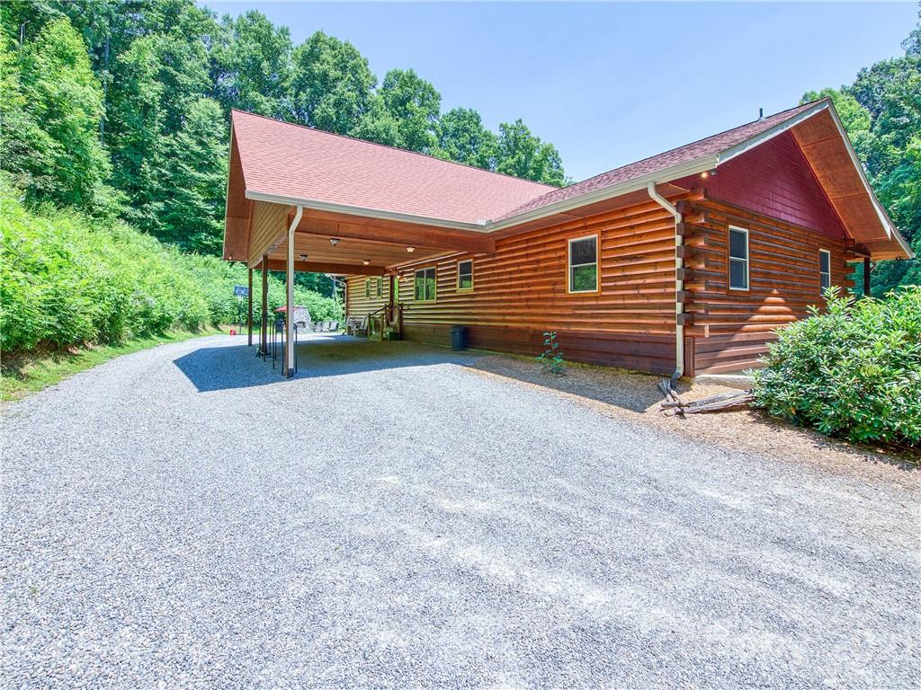 273 Mellow Springs Road Waynesville, NC 28786 - Photo 3 of 40 a view of a house with a yard and a garage