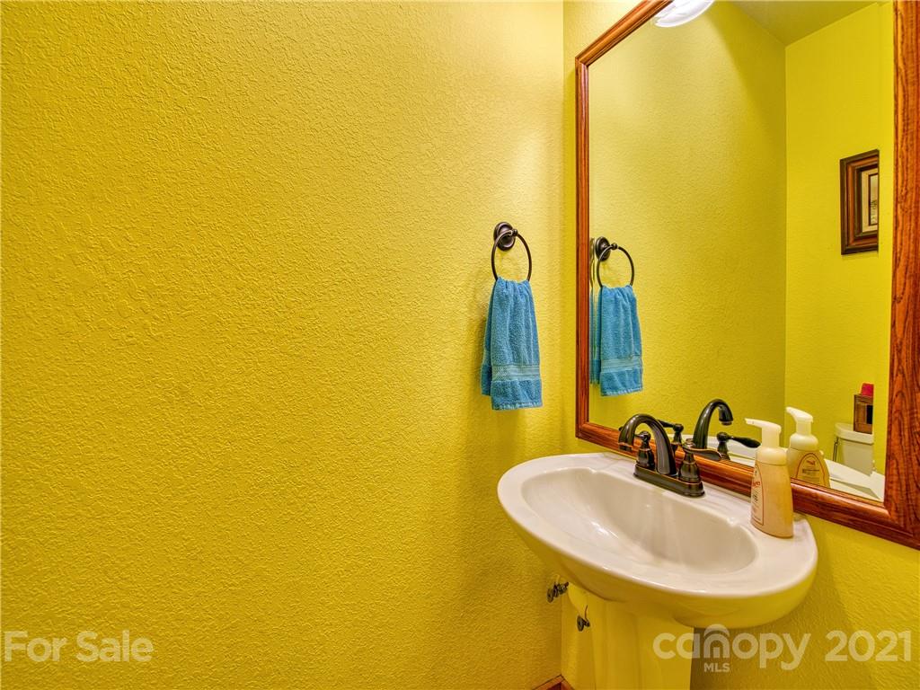 273 Mellow Springs Road Waynesville, NC 28786 - Photo 26 of 40 a bathroom with a sink and a mirror