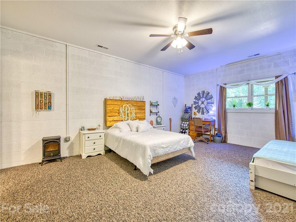 273 Mellow Springs Road Waynesville, NC 28786 - Photo 29 of 40 a bed room with a bed and a couch