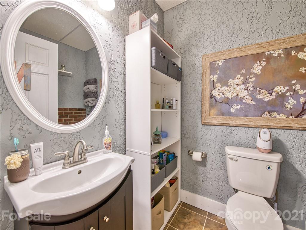 273 Mellow Springs Road Waynesville, NC 28786 - Photo 31 of 40 a bathroom with a toilet a sink and a mirror