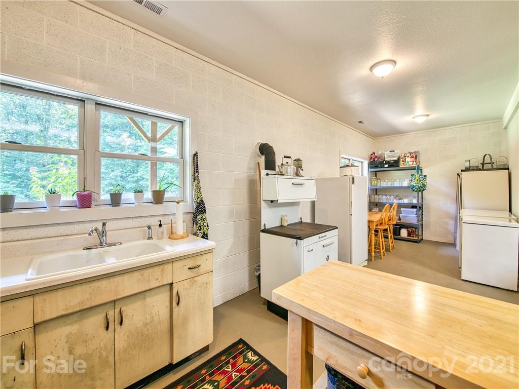 273 Mellow Springs Road Waynesville, NC 28786 - Photo 32 of 40 a kitchen with a sink a stove and a refrigerator