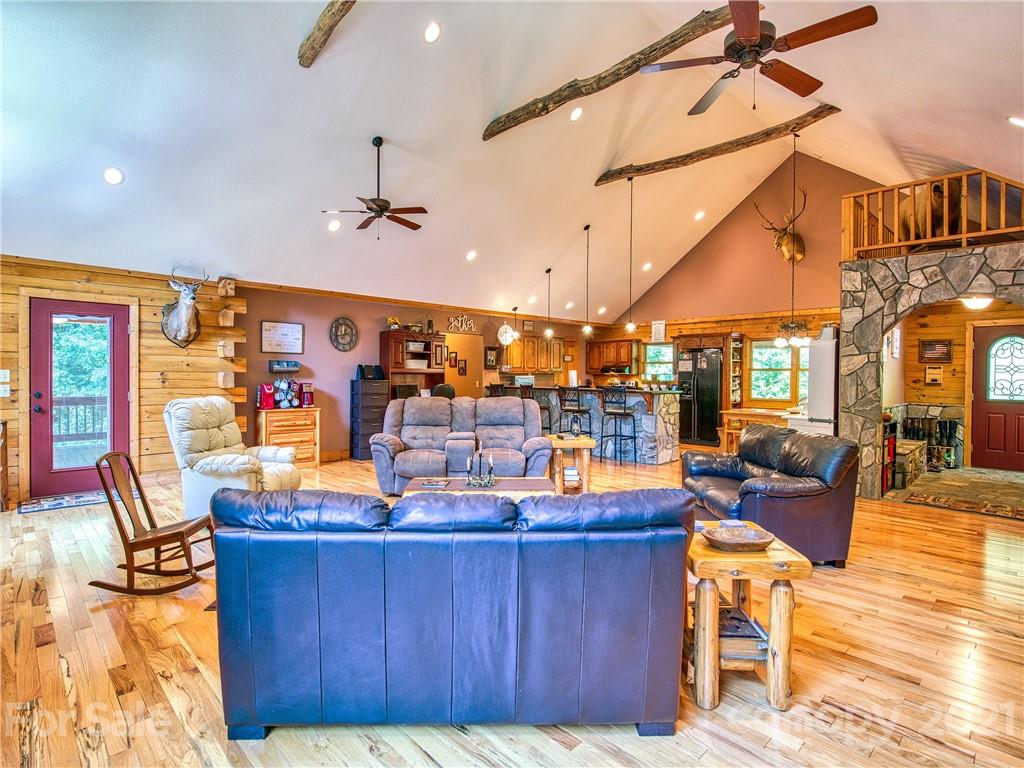 273 Mellow Springs Road Waynesville, NC 28786 - Photo 9 of 40 a living room with lots of furniture and a chandelier