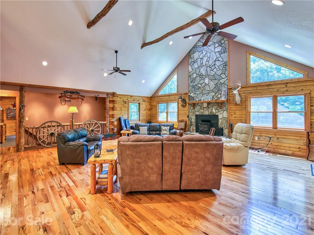 273 Mellow Springs Road Waynesville, NC 28786 - Photo 10 of 40 a living room with furniture and a chandelier
