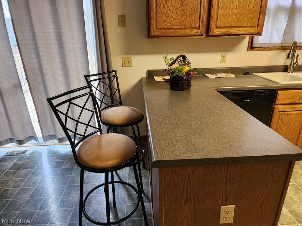 176 Overhill Road Youngstown, OH 44512 - Photo 9 of 20 Kitchen featuring tile flooring, sink, a breakfast bar area, and dishwasher