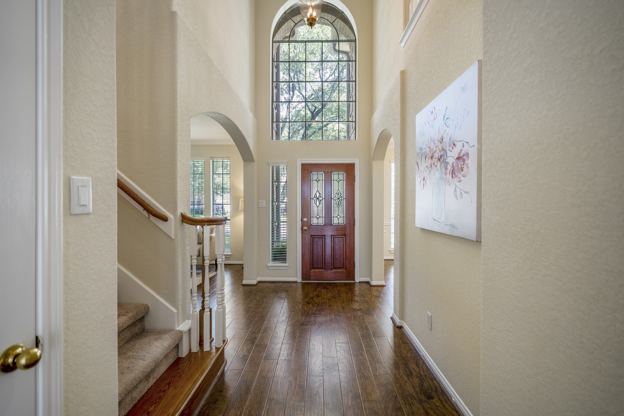5807 Sequoia Trace Court Spring, TX 77379 - Photo 19 of 50 Looking back toward the foyer, the two-story entry brings in natural light through the arched front window, with the formal living and dining rooms branching off on either side and the staircase leading up to the game room and secondary bedrooms.
