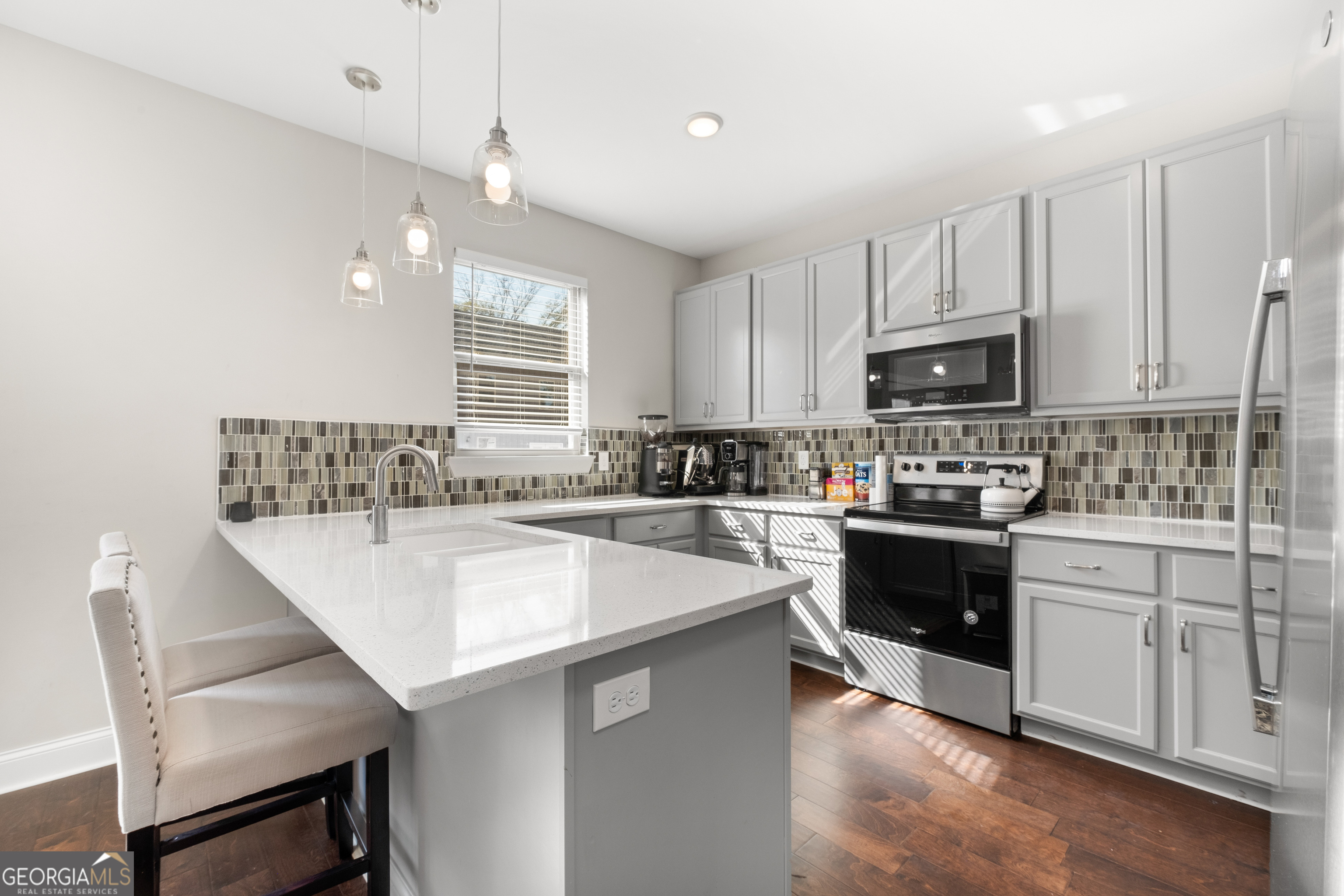3775 Jack Vernon Circle Powder Springs, GA 30127 - Photo 11 of 33 a kitchen with kitchen island white cabinets appliances and window