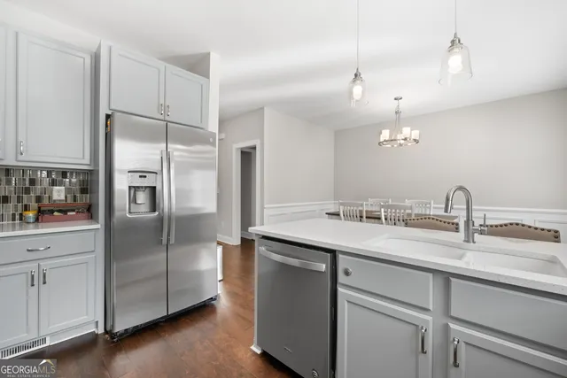 a kitchen with a sink and refrigerator