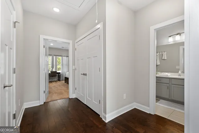 a view of a room with bathroom and wooden floor
