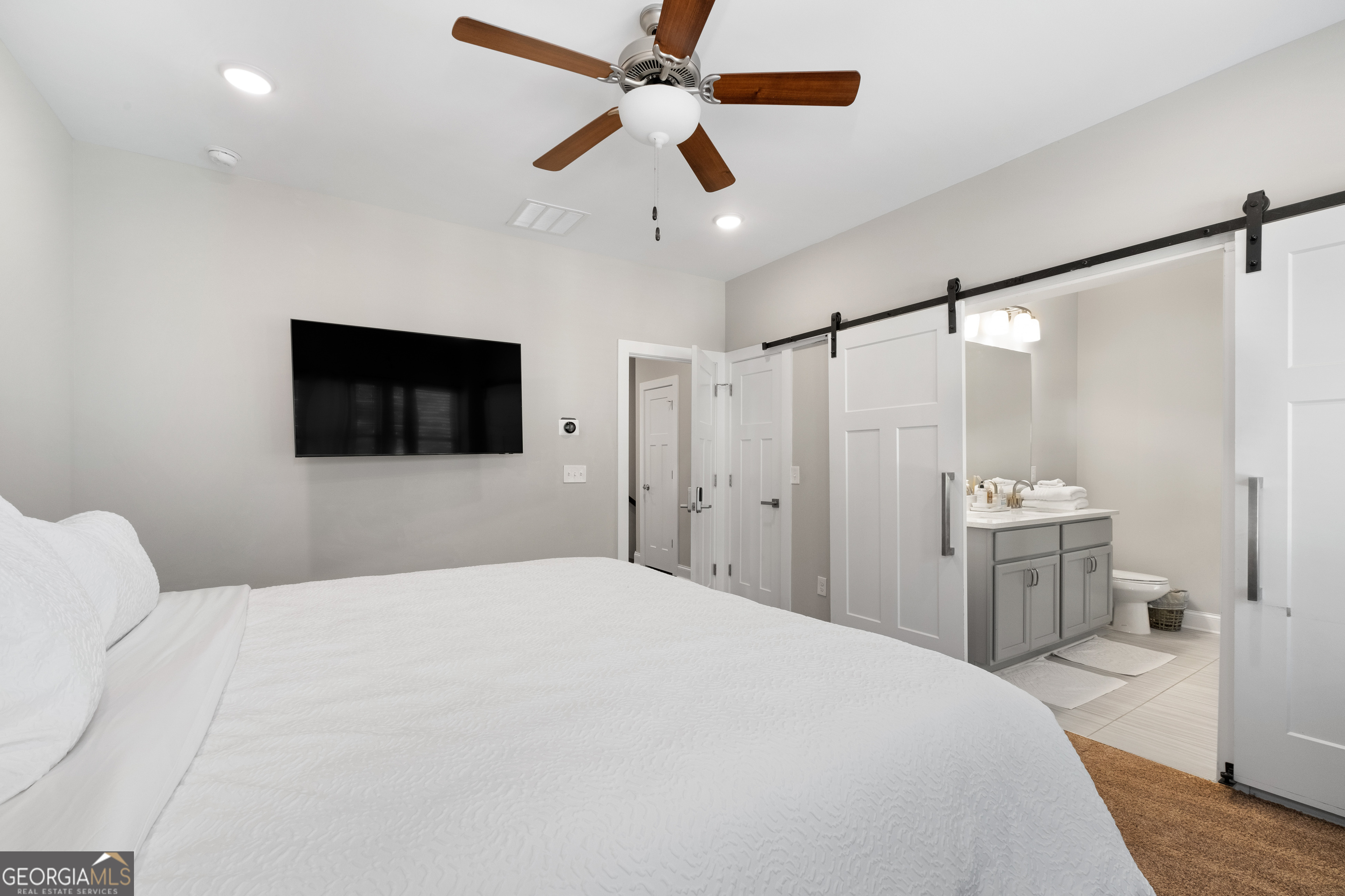 3775 Jack Vernon Circle Powder Springs, GA 30127 - Photo 17 of 33 a bedroom with a large bed and a flat tv screen