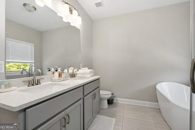 a bathroom with a sink a toilet and mirror